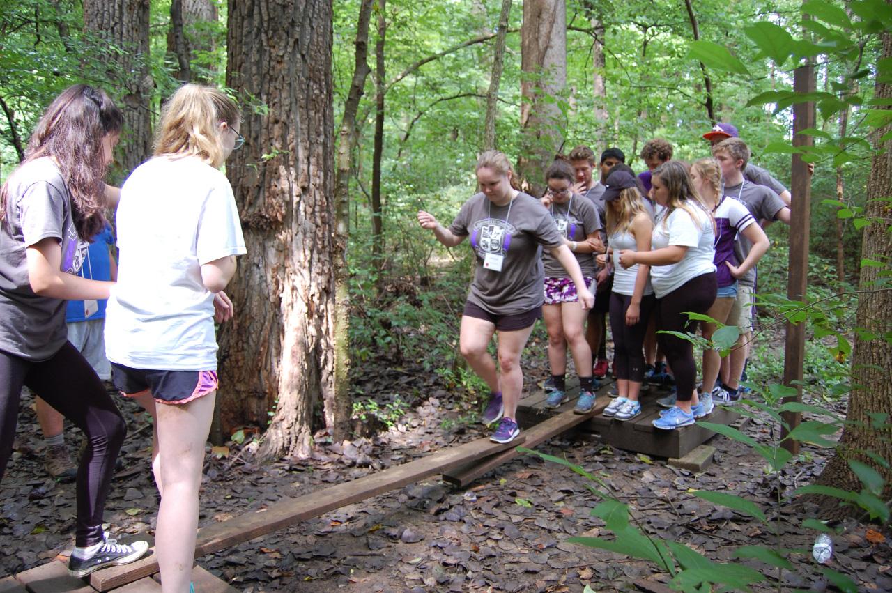 Honors freshmen work together to complete a challenge course at the freshmen retreat.