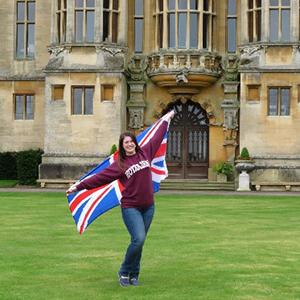 Kelly holding the British flag in front of Harlaxton